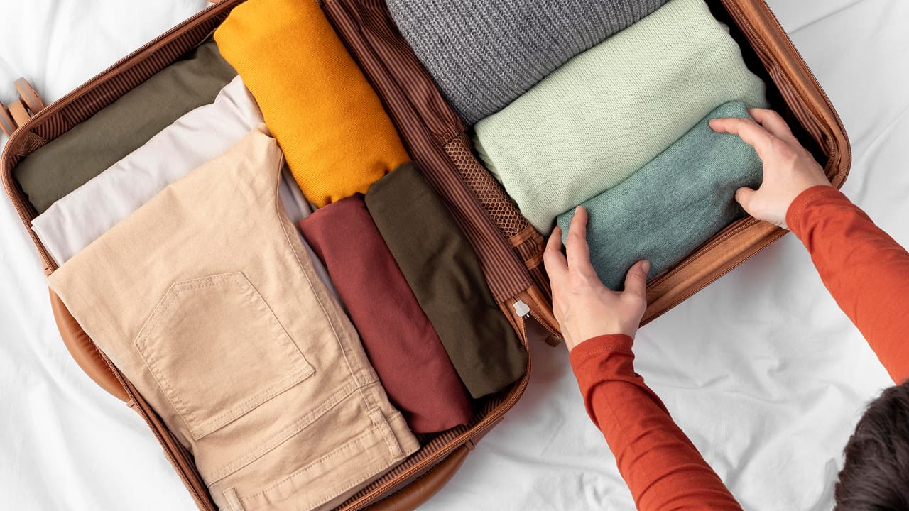Opened luggage with folded clothes before starting the journey
