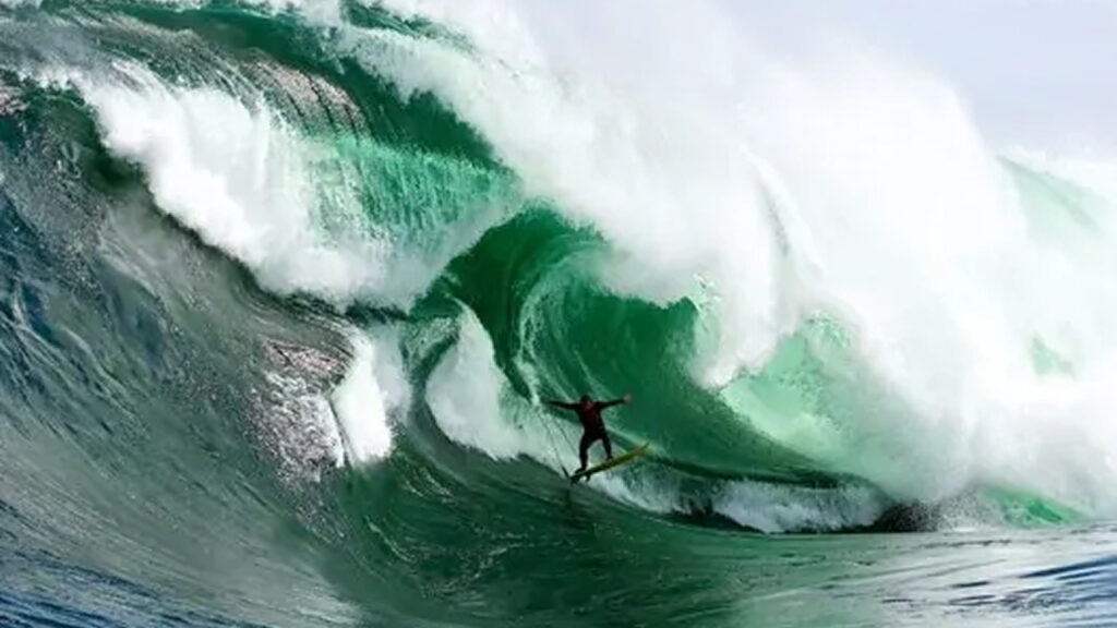 A man is surfing on the waves