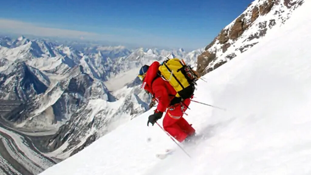A man is skiing on the snowy mountains
