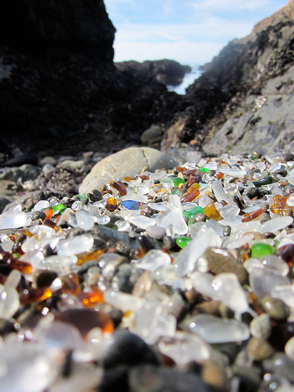 a side view of glass beach from shore