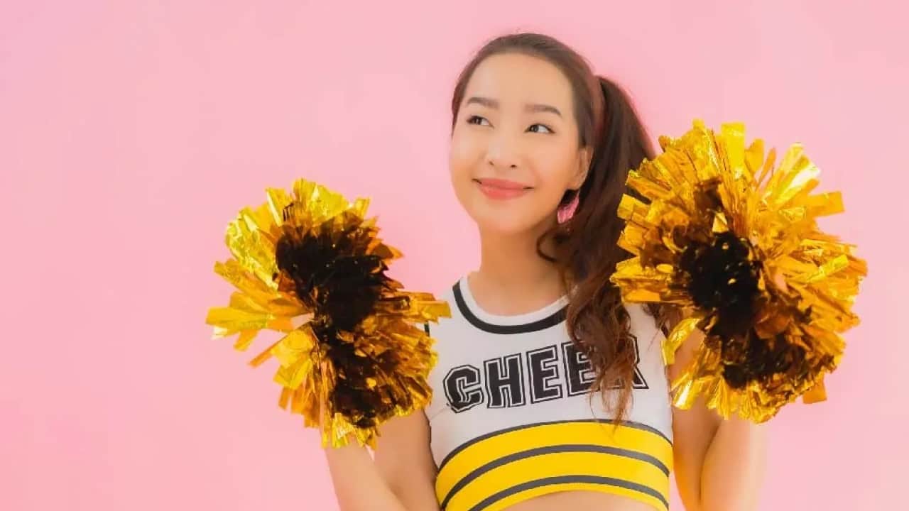 A cute girl posing as a cheerleader