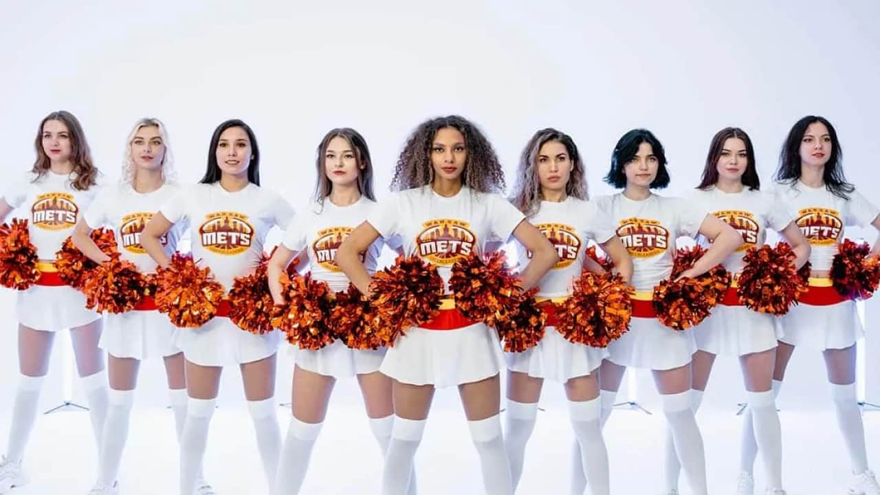 a group of cheerleaders wearing white and red uniform