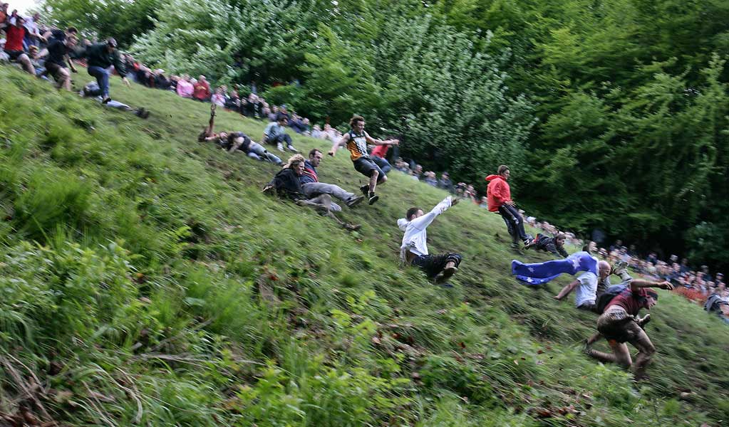 people are playing Cheese Rolling which is an unusual sport