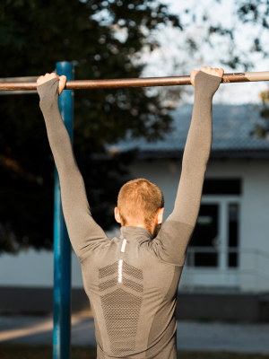 A boy holding a pull-up bar