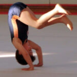 a child is rolling forward which is the first skill a gymnast taught