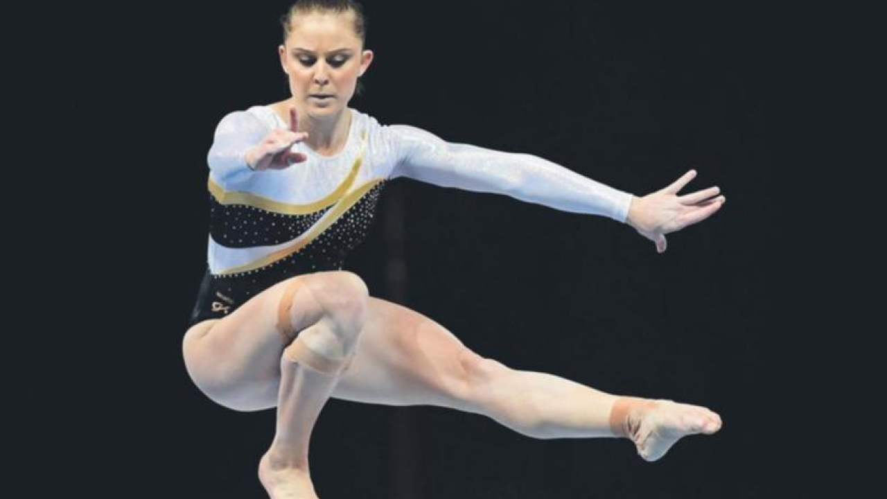 a girl is performing some elite level gymnastics