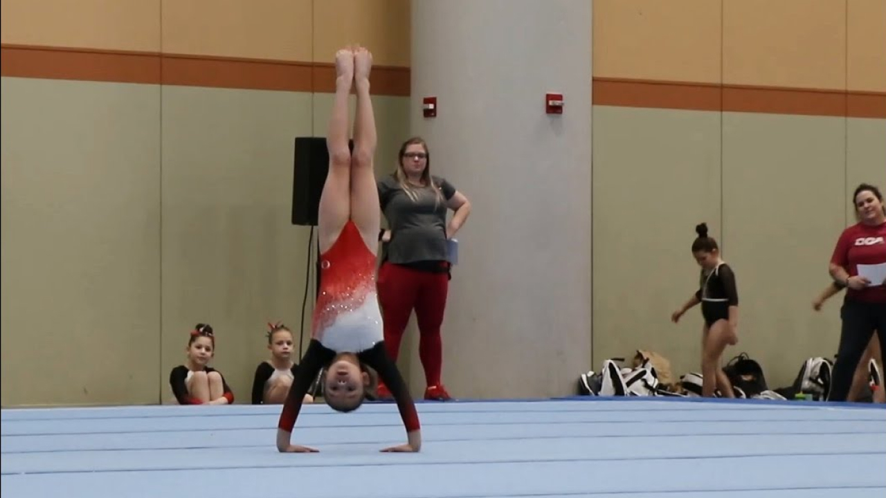 level 4 of gymnastic in which a girl is standing on her hands