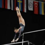 a girl is realizing and grasping on the high gymnastic bars