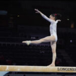 a girl is turning on one foot which is a gymnastic artistry