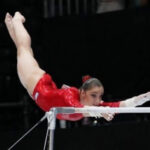 a girl is twisting on a beam which is the hardest athletic skills