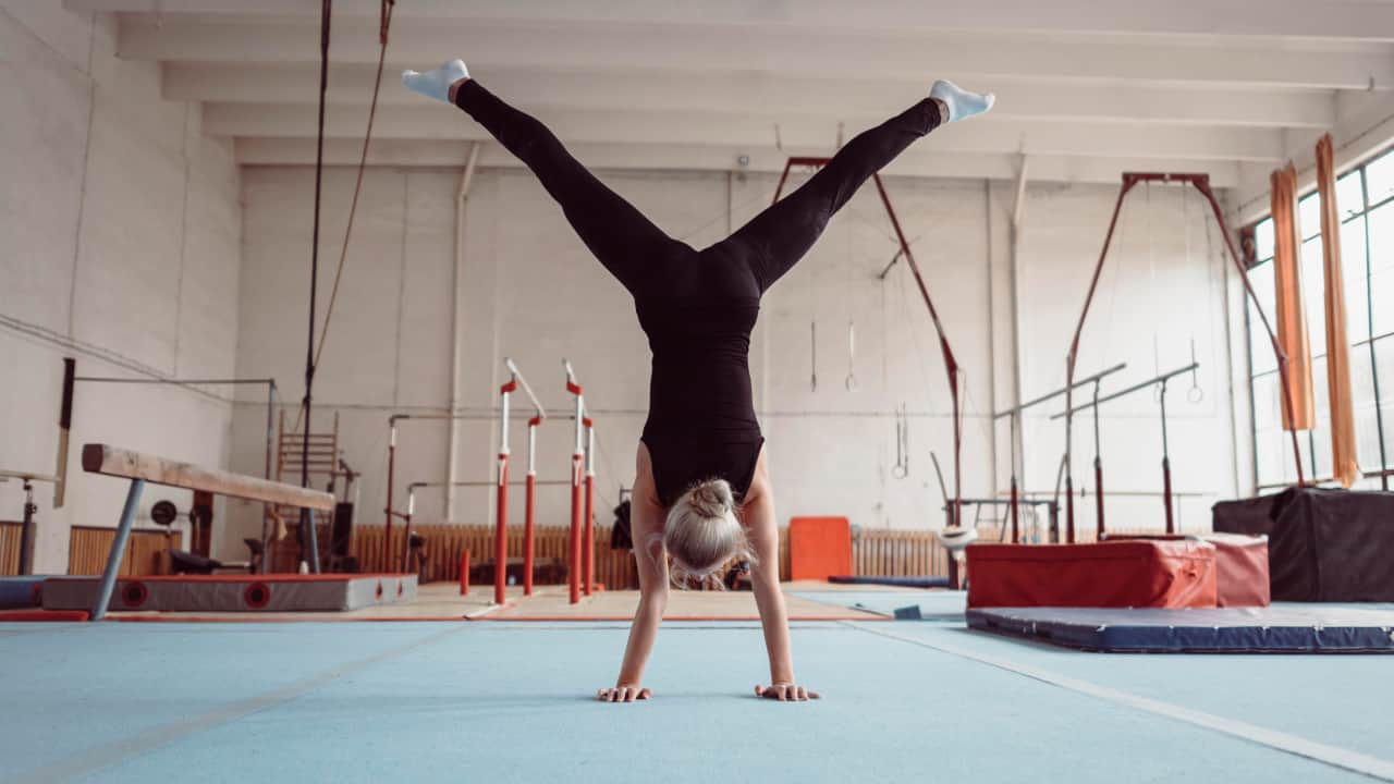 back view of women doing handstand