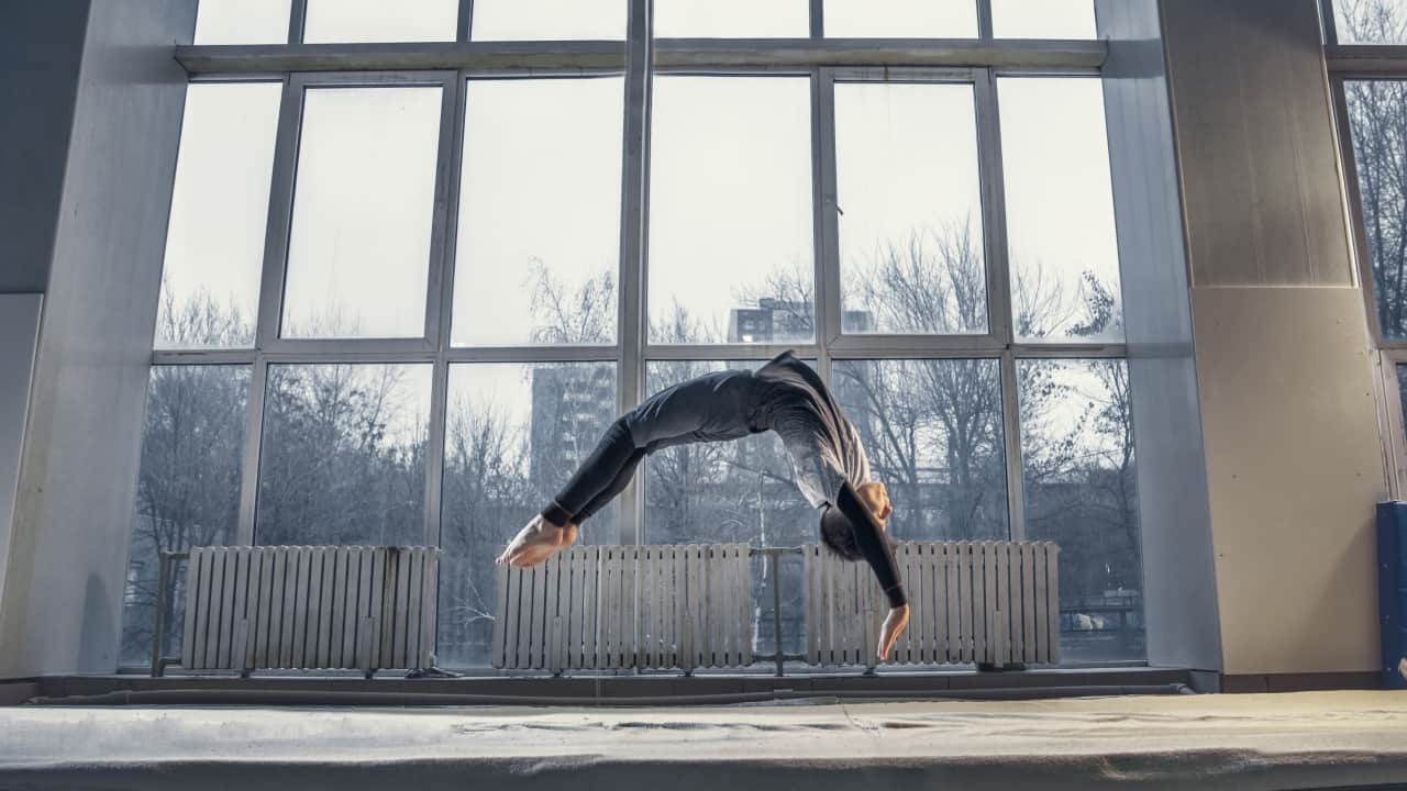 little male gymnast doing flexible activity