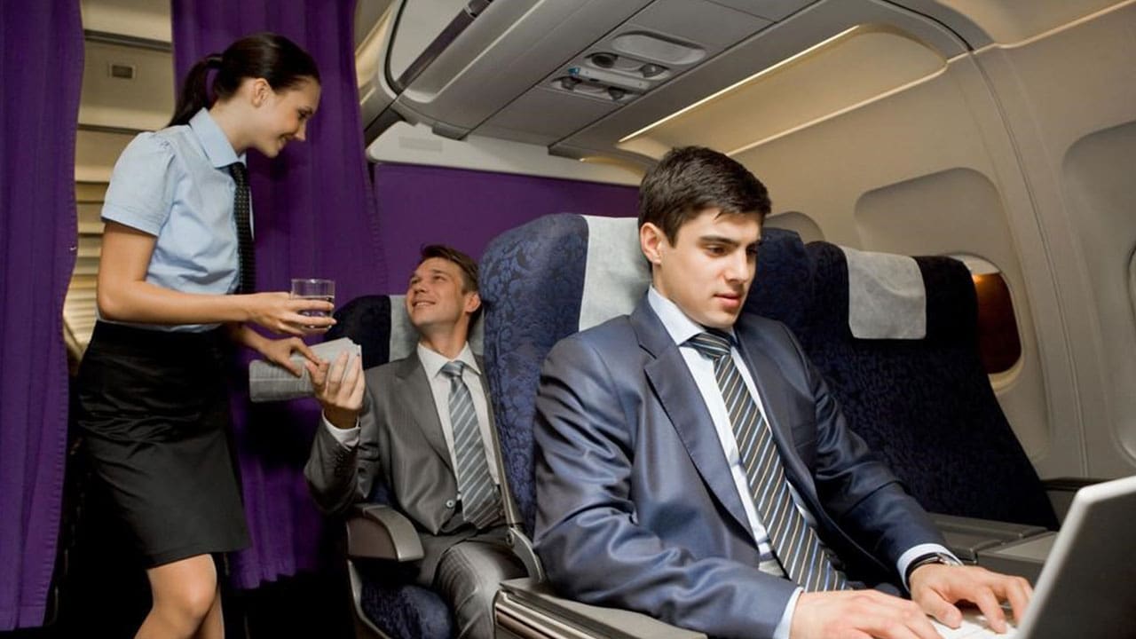 An Air hostess greeting a passenger while traveling 