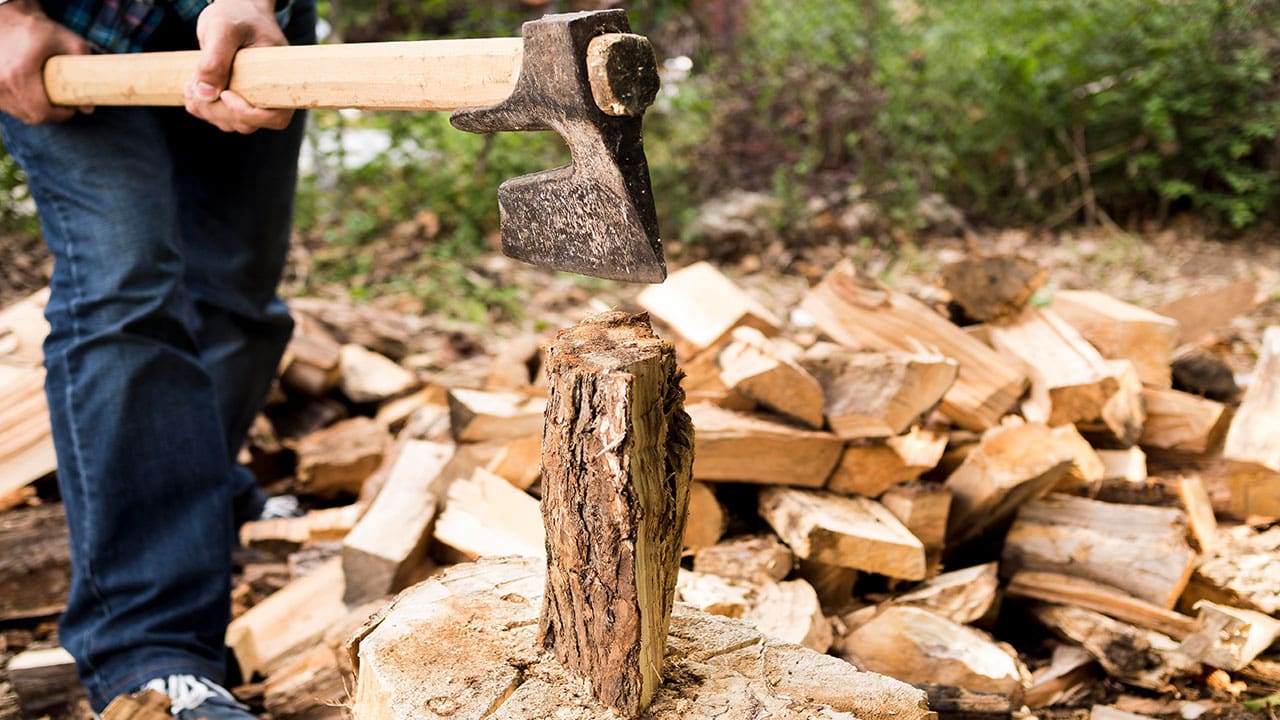 man chopping some wood causing deforestation