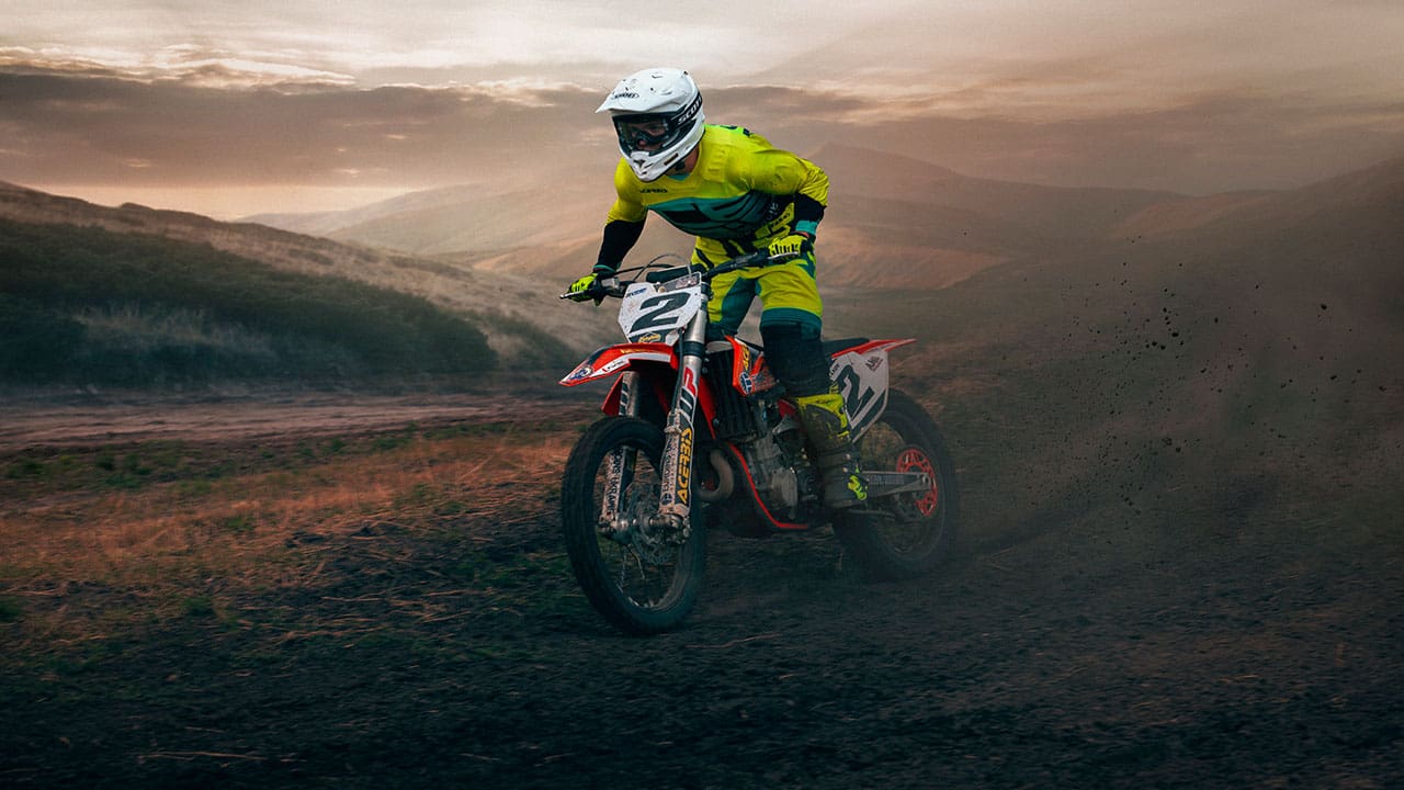 motocross rider racing by standing on the bike