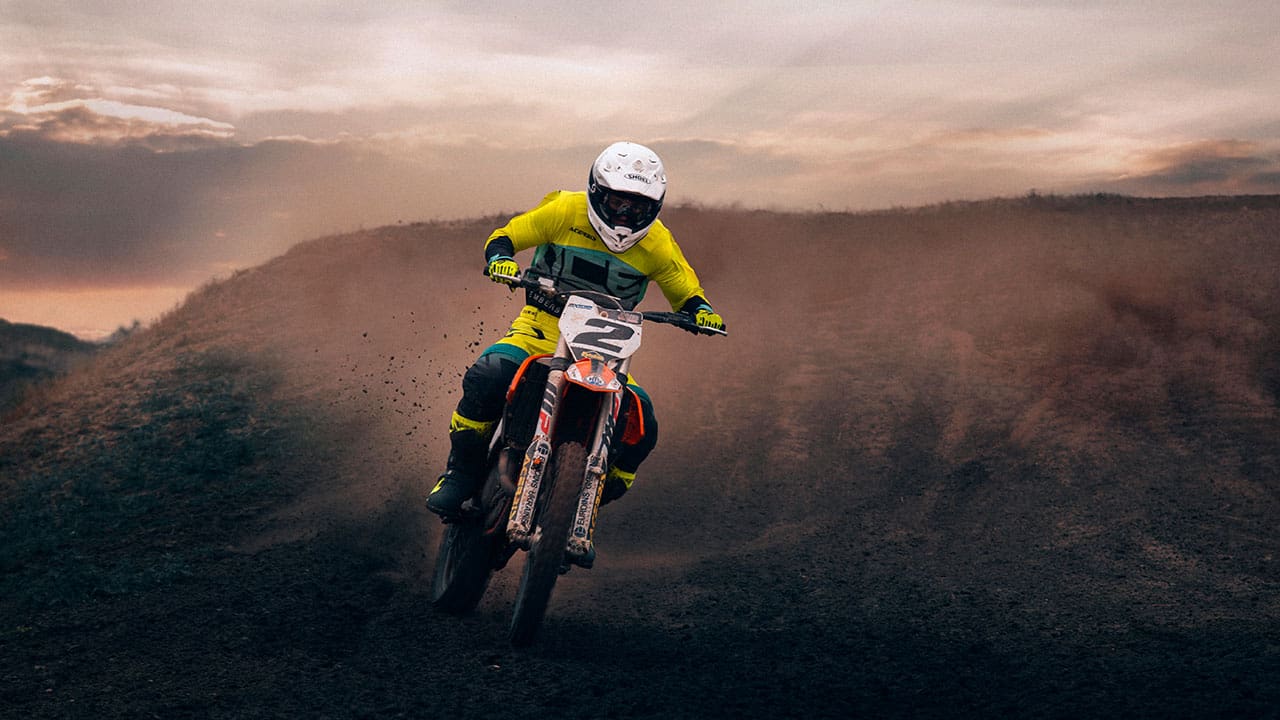 Motocross mounted motorcyclist doing a race on a dirt track