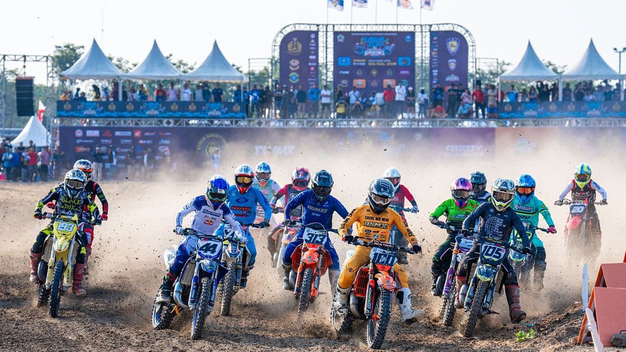 racers taking a turn in supercross racing