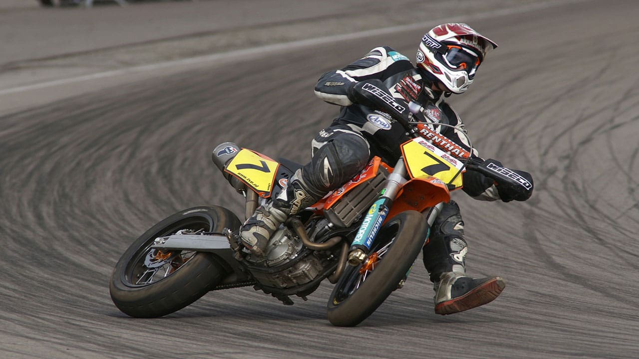 racer is taking a turn in supermoto sport