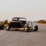 old vintage car parked in the middle of the road