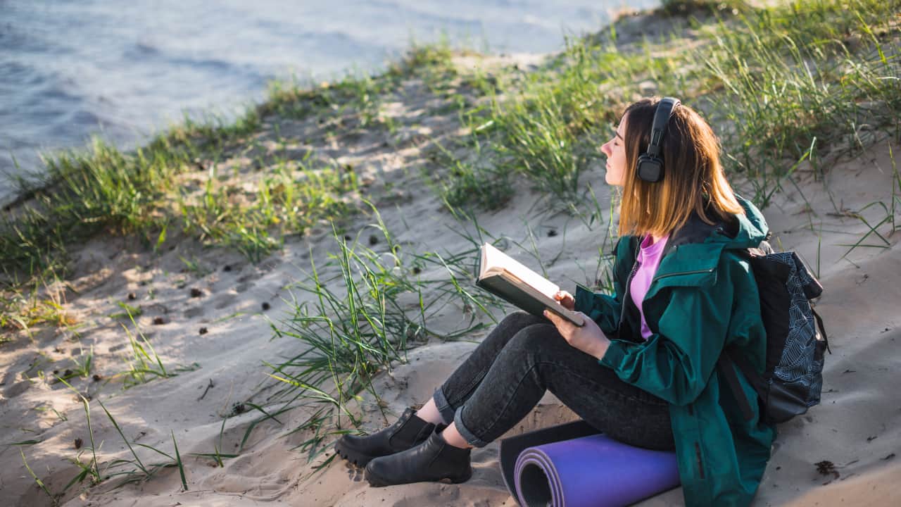 women with books enjoying music