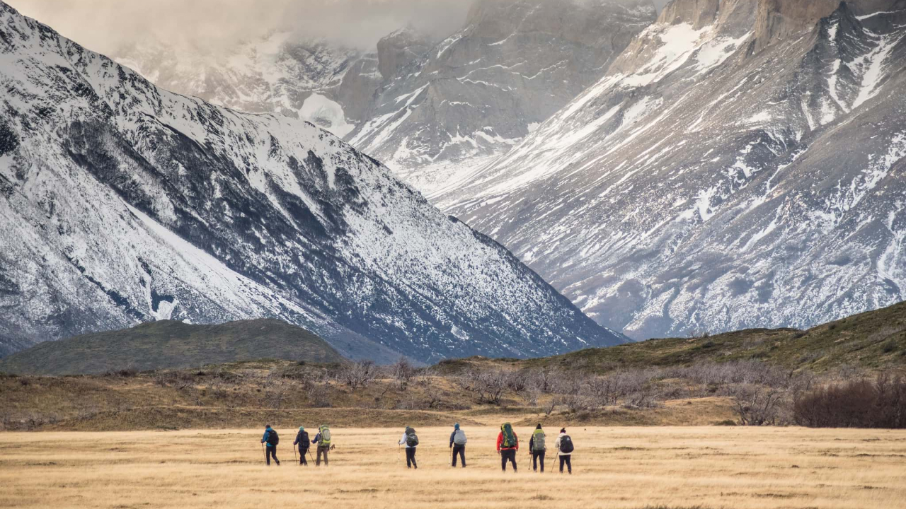 hikers with backpack in snowy mountains