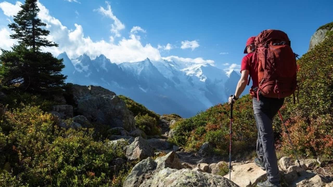 a beautiful view of mountains and a man is going for hiking