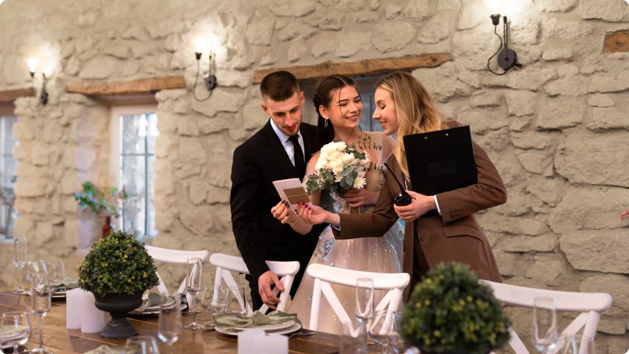 wedding planner talking to groom and bride