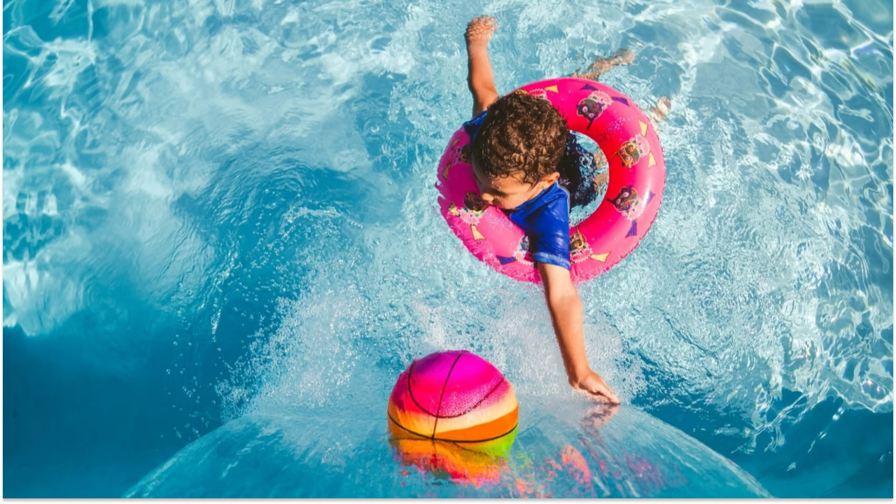 a kid playing in a pool