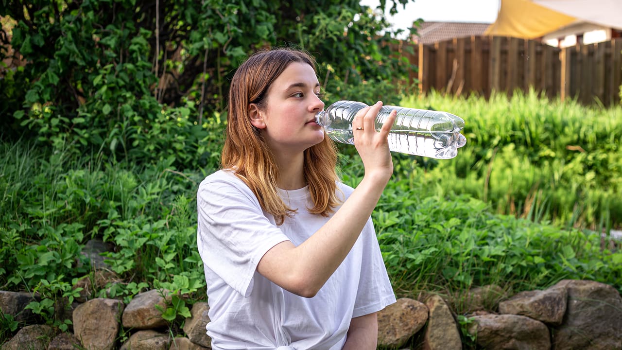 a young girl drinking water