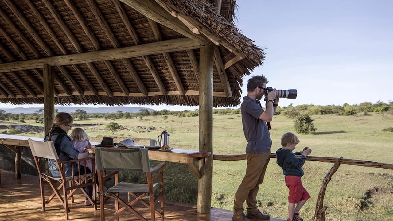 A family enjoying the views in Asilia Family Camps and taking photographs