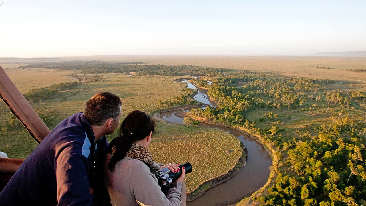 A couple enjoying the views of Maasai Mara from the top 