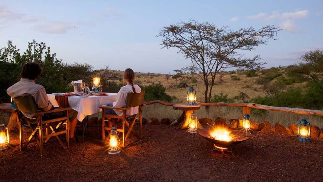 couple enjoying views of safari located in kenya which is the luxury safari for honeymoon