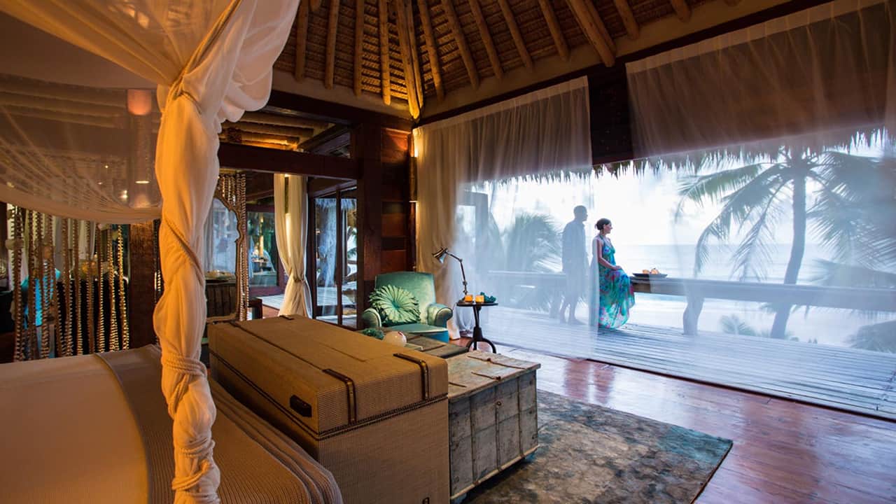 A beautiful room in which a couple standing in a balcony and enjoying the outside view