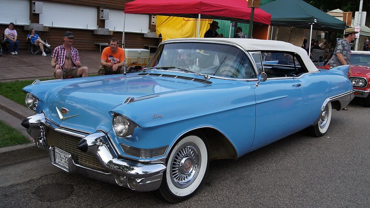 A blue Cadillac Eldorado Biarritz is parked on the side of the road