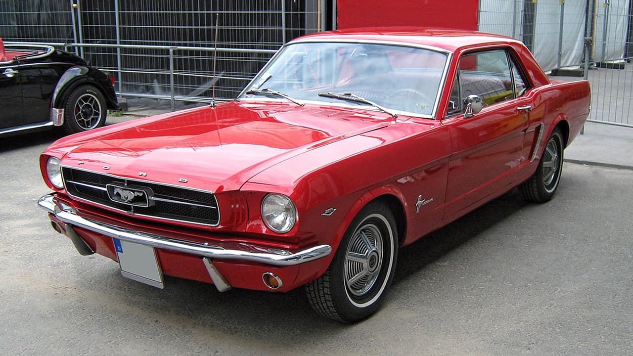 A beautiful red color classic convertible Ford Mustang is parked