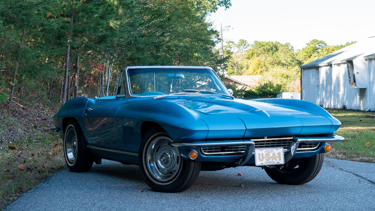 A side view of a Chevrolet Corvette Sting Ray Convertible on the road