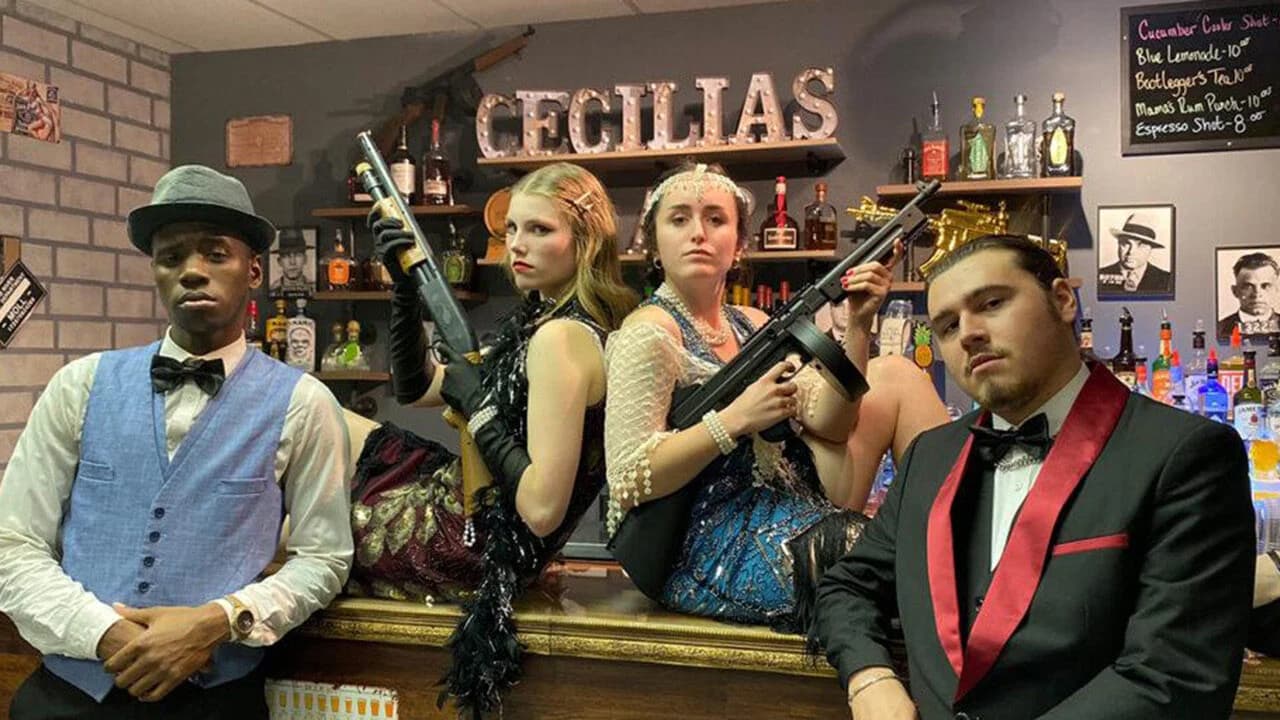 Four characters are posing for a picture at a Murder Mystery Dinner Show