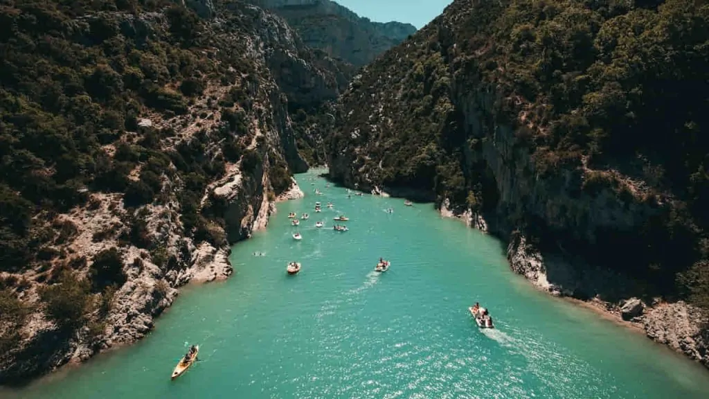 Photo of People Riding Kayaks Near Mountains