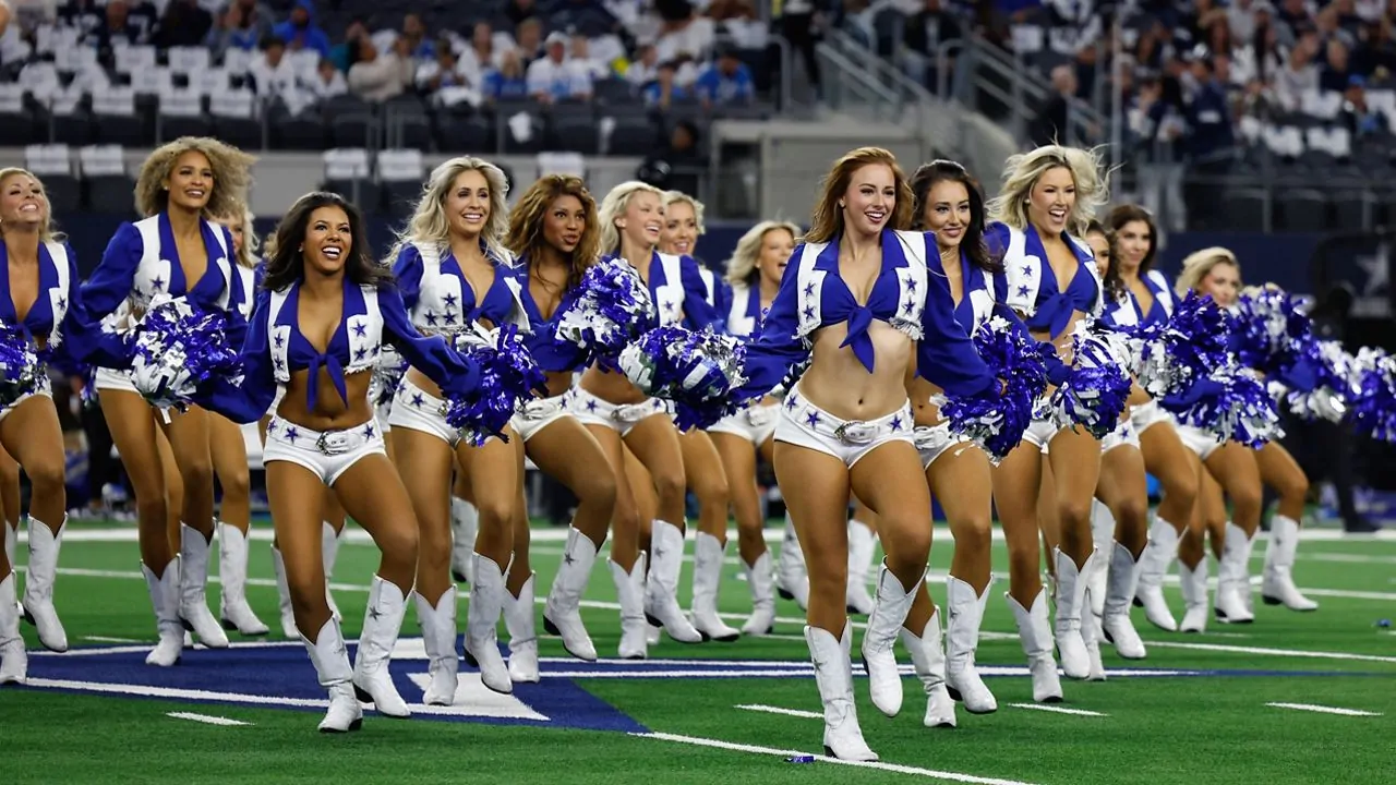 a group of Dallas cowboy cheerleaders performing cheer stunts