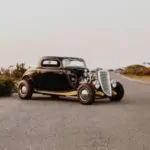 old vintage car parked in the middle of the road