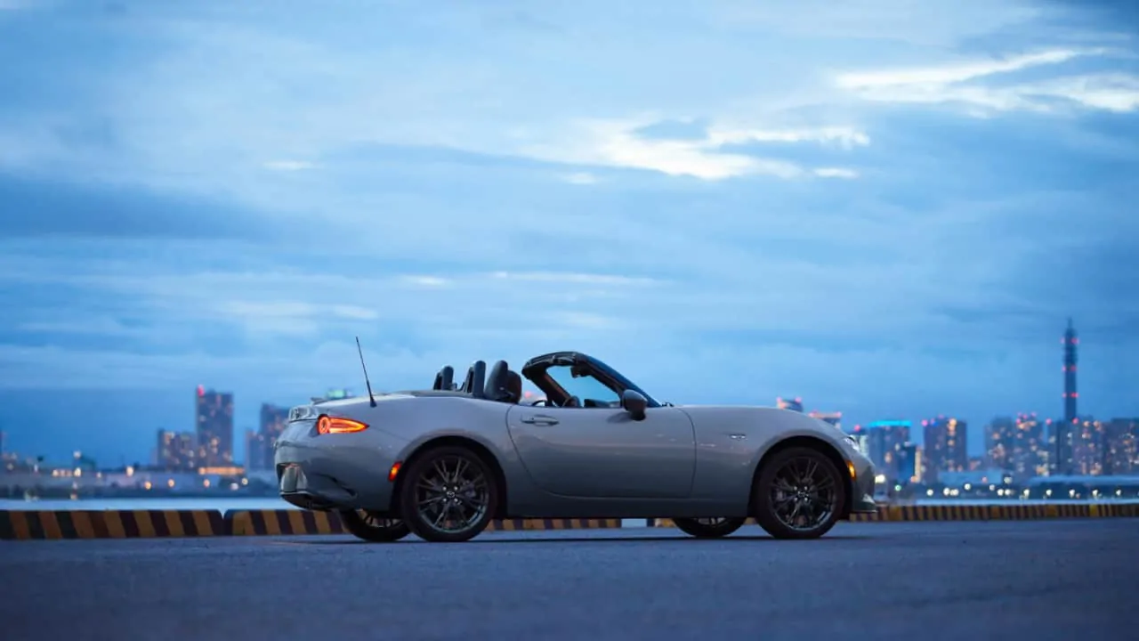 Pretty Blue sky and miata standing on a roadside